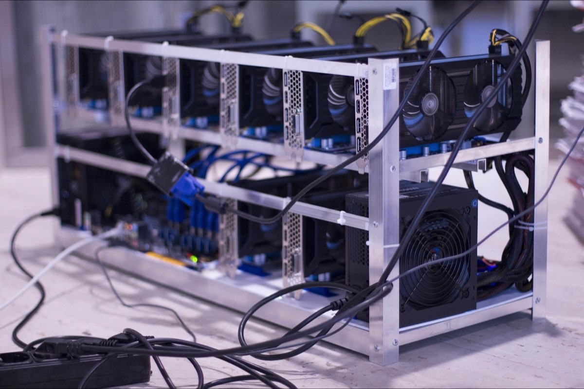 Rack of ASIC miners in a mining hall